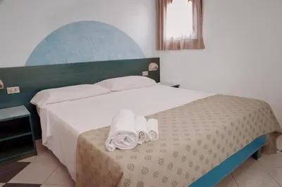 Letto o letti in una camera di Appartamento presso Residence Verdemare